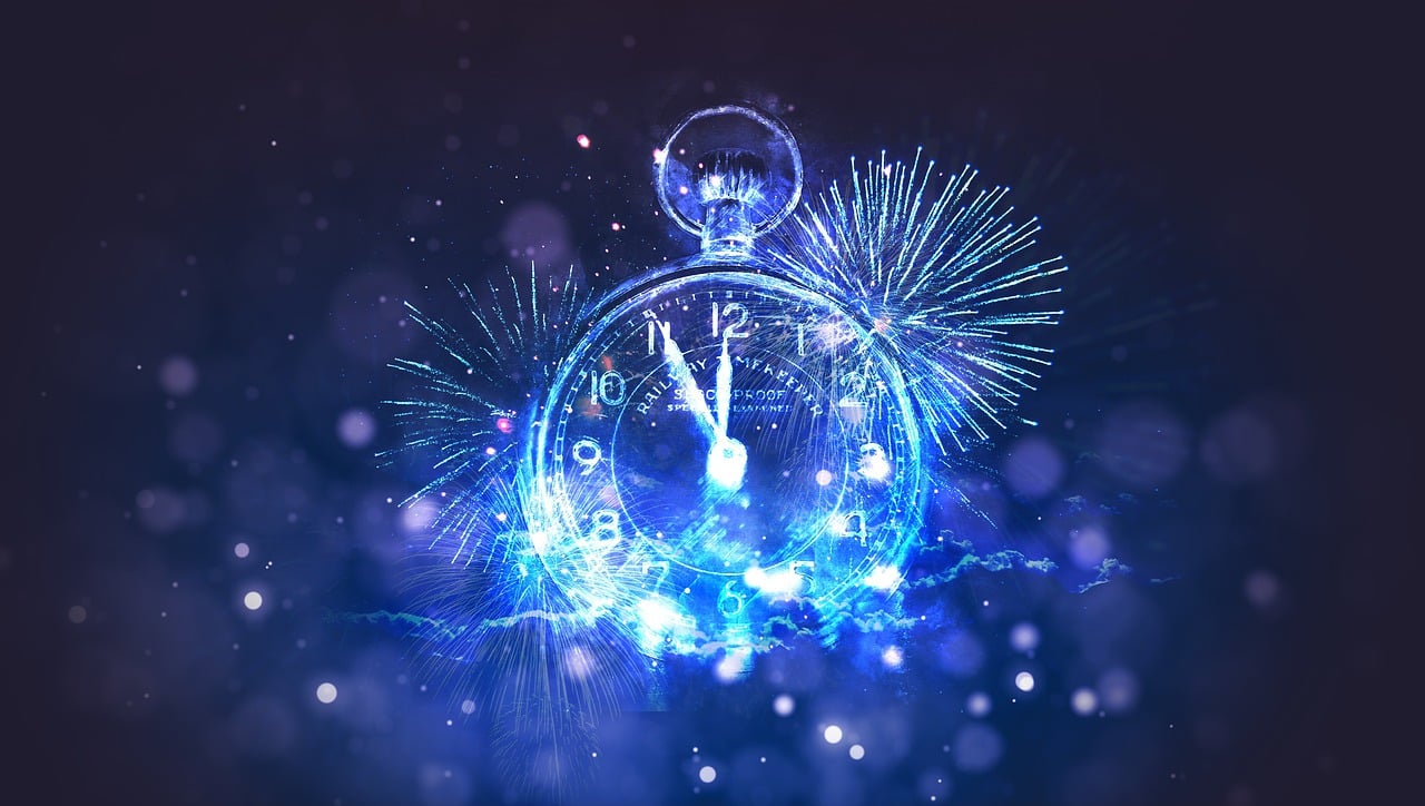 A clock and fireworks signifying the new year